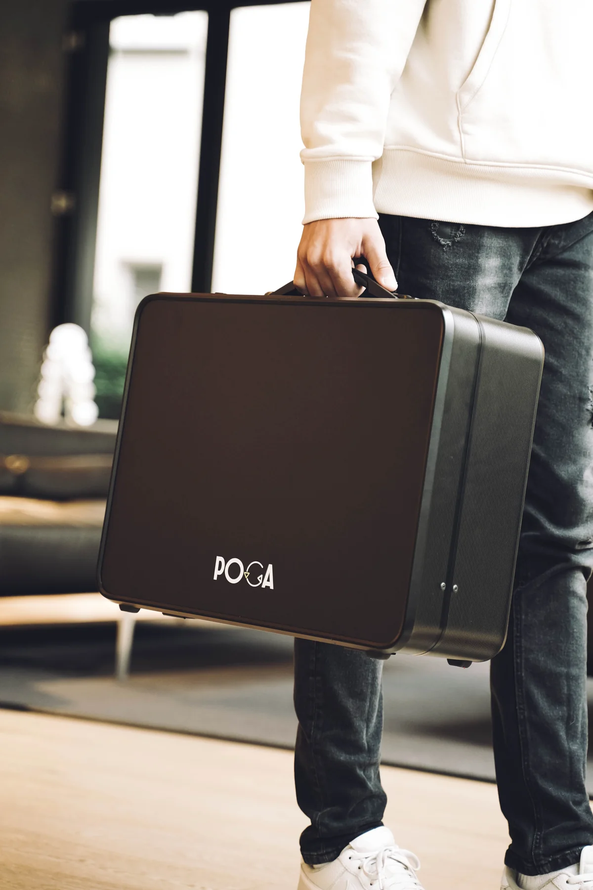 compact gaming case for PS5, Xbox & PS4 — Person carrying POGA Arc case with handle