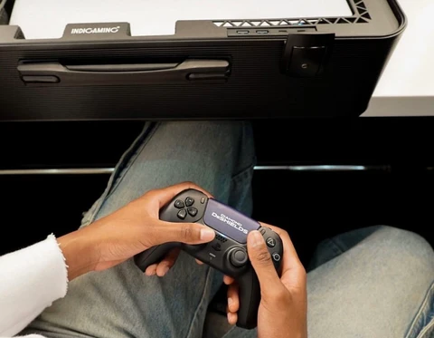 Traveler using a controller beside an open POGA gaming case