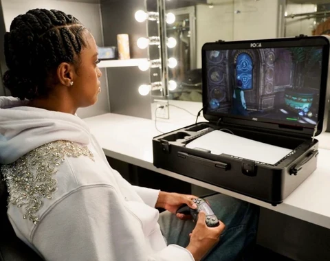 Gamer playing beside an open portable gaming station