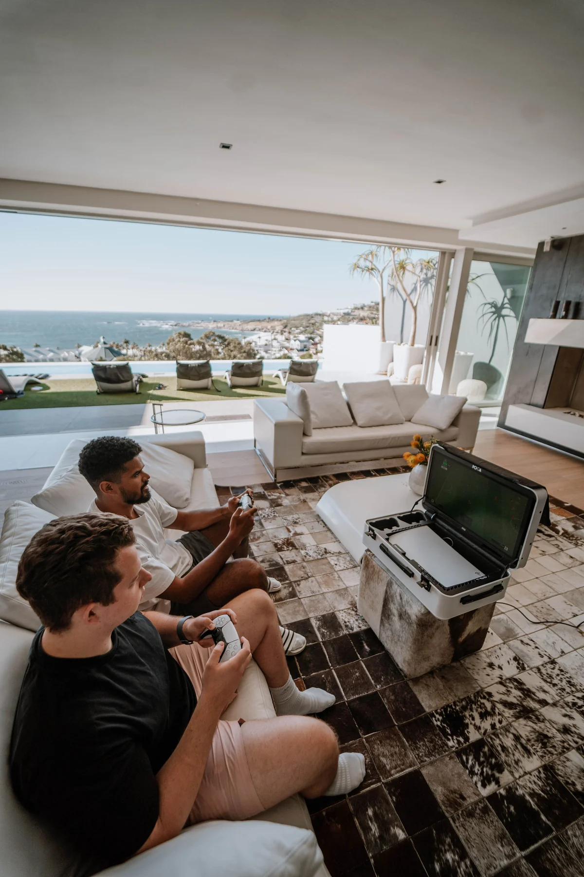Premium portable gaming station price value shown with POGA Lux in luxury setting with ocean view