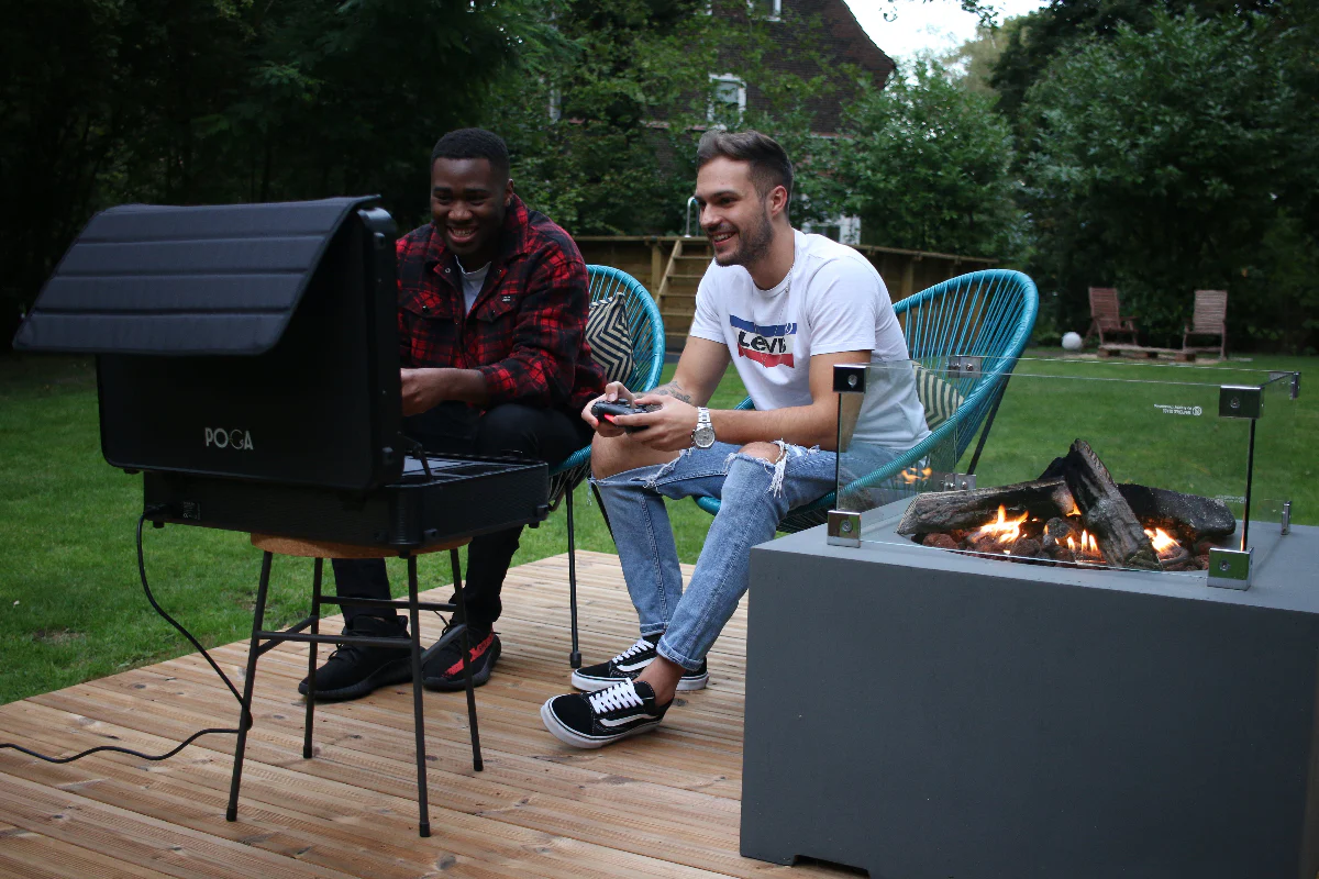 Outdoor gaming with friends - POGA Pro case enabling social gaming experience in garden with firepit