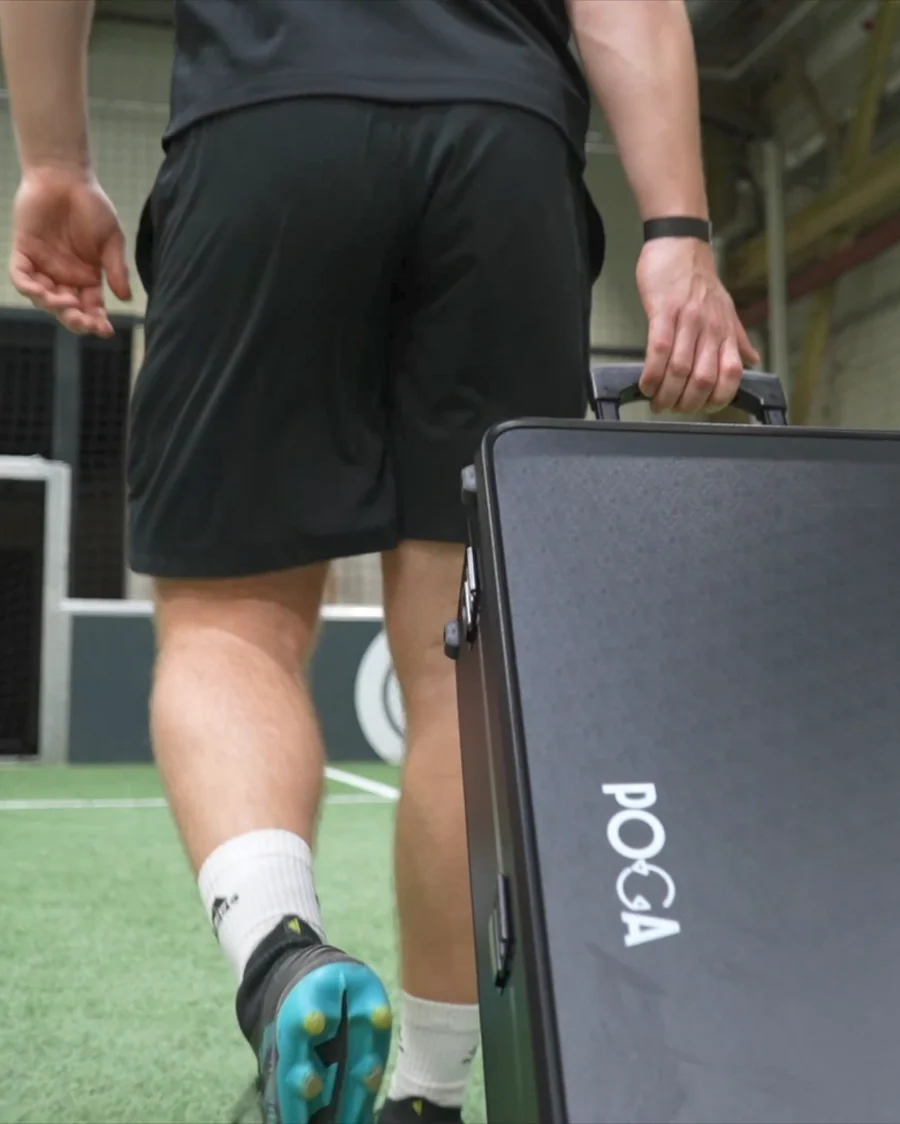 Content creator carrying a closed POGA portable gaming station on a sports field